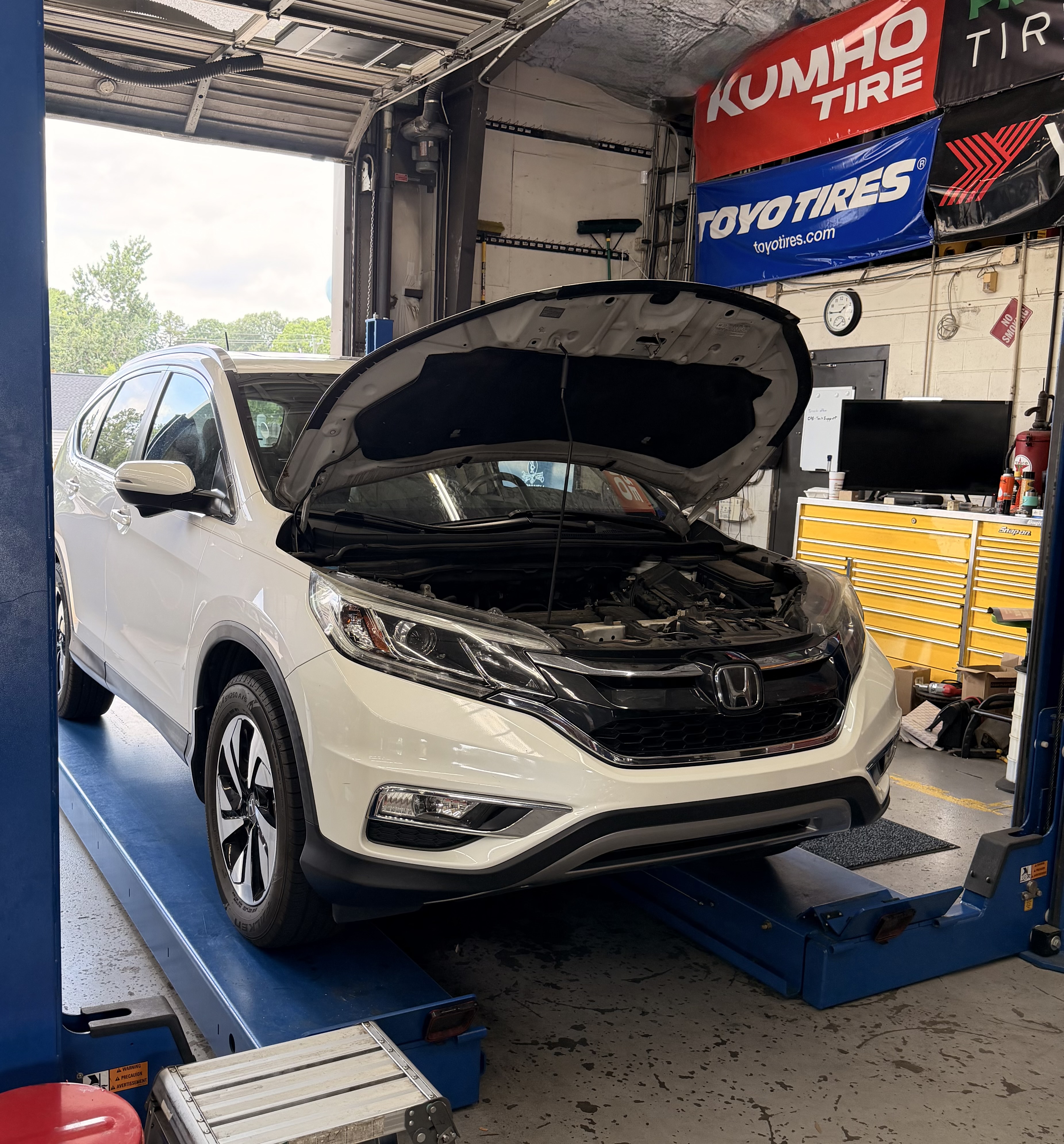 Honda CR-V on the lift in the Modern Service repair bay